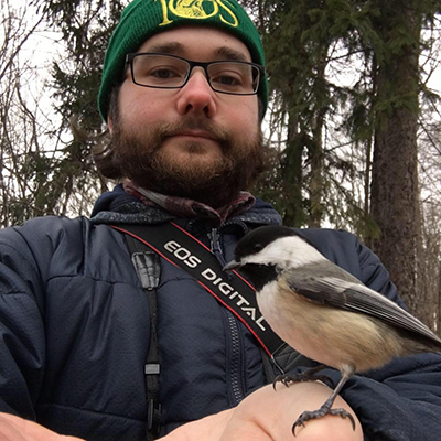 Ethan Gyllenhaal and a Black-capped Chickadee